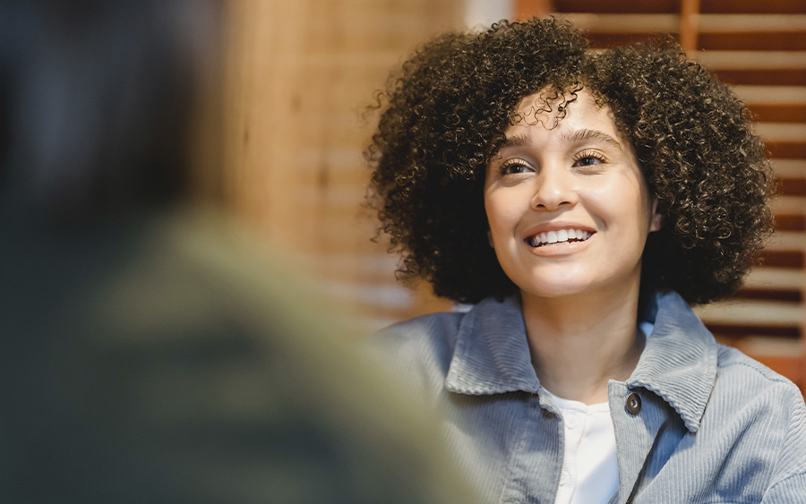 Woman starting her first therapy session. This represents how starting therapy can be a transformative experience when you're motivated to make the most out of it.