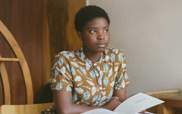 Young Black woman lost in her thoughts while she was studying. This represents how constant worry, overthinking and difficulty concentrating can be signs you might have an anxiety disorder.