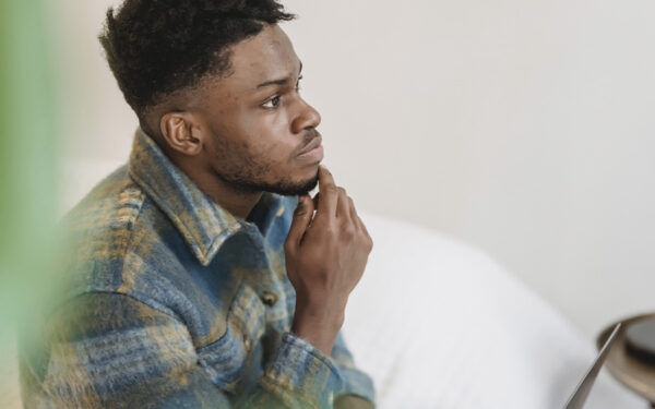 BIPOC man with a thoughtful and focused look. This represents how it can be helpful to think if anxiety is always a bad thing and how we can use it to our advantage.