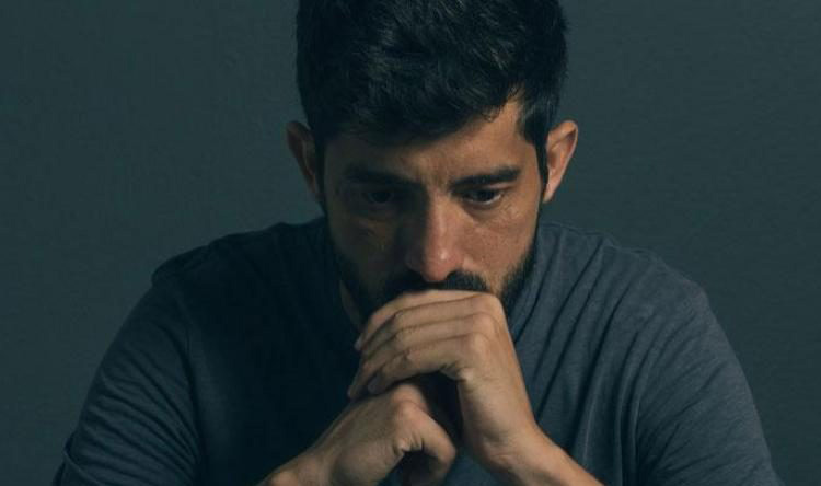 Man with chin in hands looking distraught before seeing a skilled psychologist in Baltimore, MD | Men's Therapy for Depression | Depression therapist in Baltimore, MD 21210 | New Connections Counseling Center" width="300" height="139"