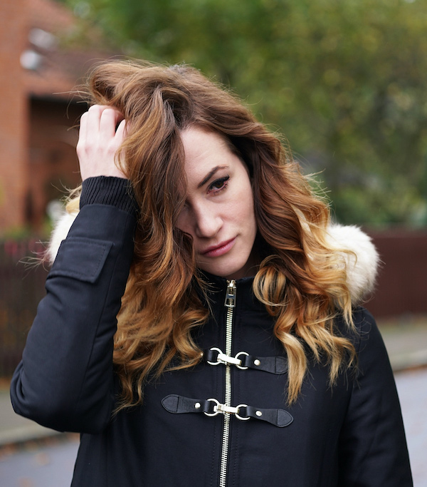 Young, depressed woman holding her hair and looking distressed after sexual assault in Baltimore, MD 21210. Read for common symptoms of sexual assault and get treatment for sexual assault or therapy for sexual assault at New Connections Counseling Center." width="332" height="221"