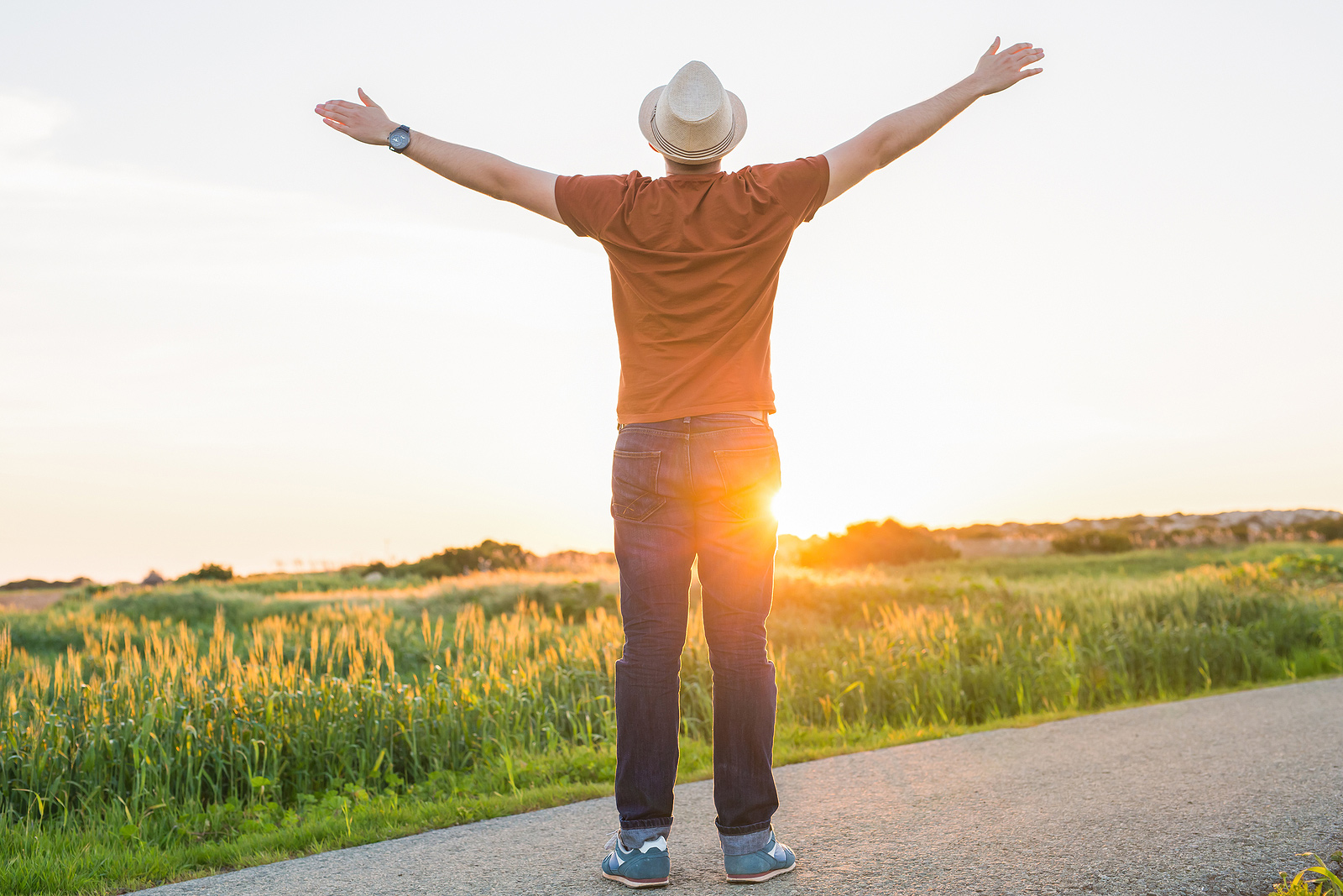 Image of a man standing in a field with his arms held up to the sky. This image depicts how freeing it can be to come out in LGBTQ therapy in Baltimore, MD. An LGBTQ affirming therapist in Baltimore, MD can help you figure out your identity and live authentically. | 21286 | 21093" width="356" height="237"