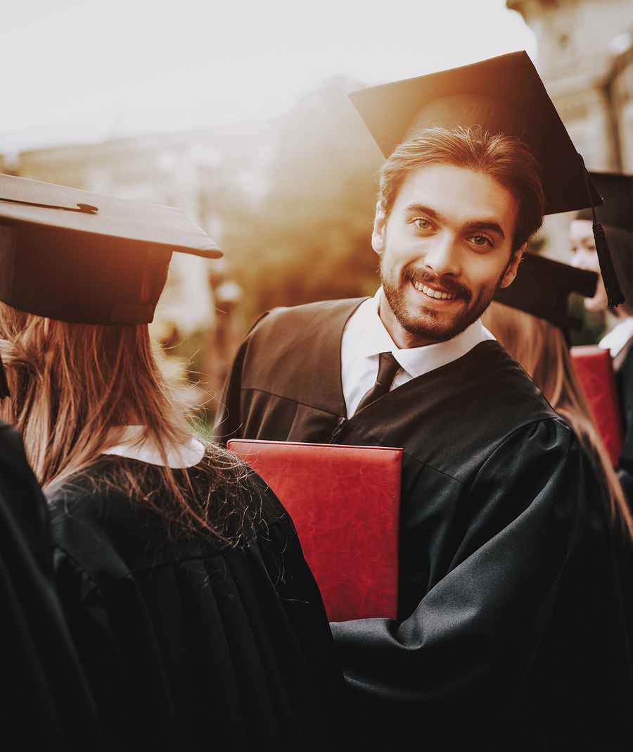 male student in a black cap and gown graduates from college. He feels confident about his career choices and graduating after therapy for college students in baltimore, MD 21210 at new connections counseling center " width="300" height="200"