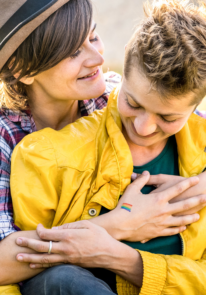 lesbian couple in the park hugging and looking in love | Counseling for life transition in Baltimore, MD 21210 | Coming out in therapy | LGTBQ affirming therapist" width="300" height="188" 