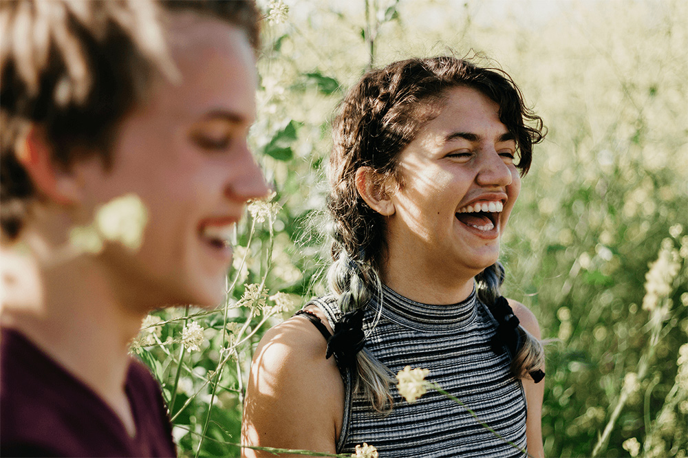 Two young adults laughing in a wheat field after receiving counseling for anxiety | Anxiety therapist | help for anxiety Psychologist in Baltimore | Anxiety Treatment with trained psychologists | New Connections Counseling Center | Baltimore, MD 21210" width="300" height="200"