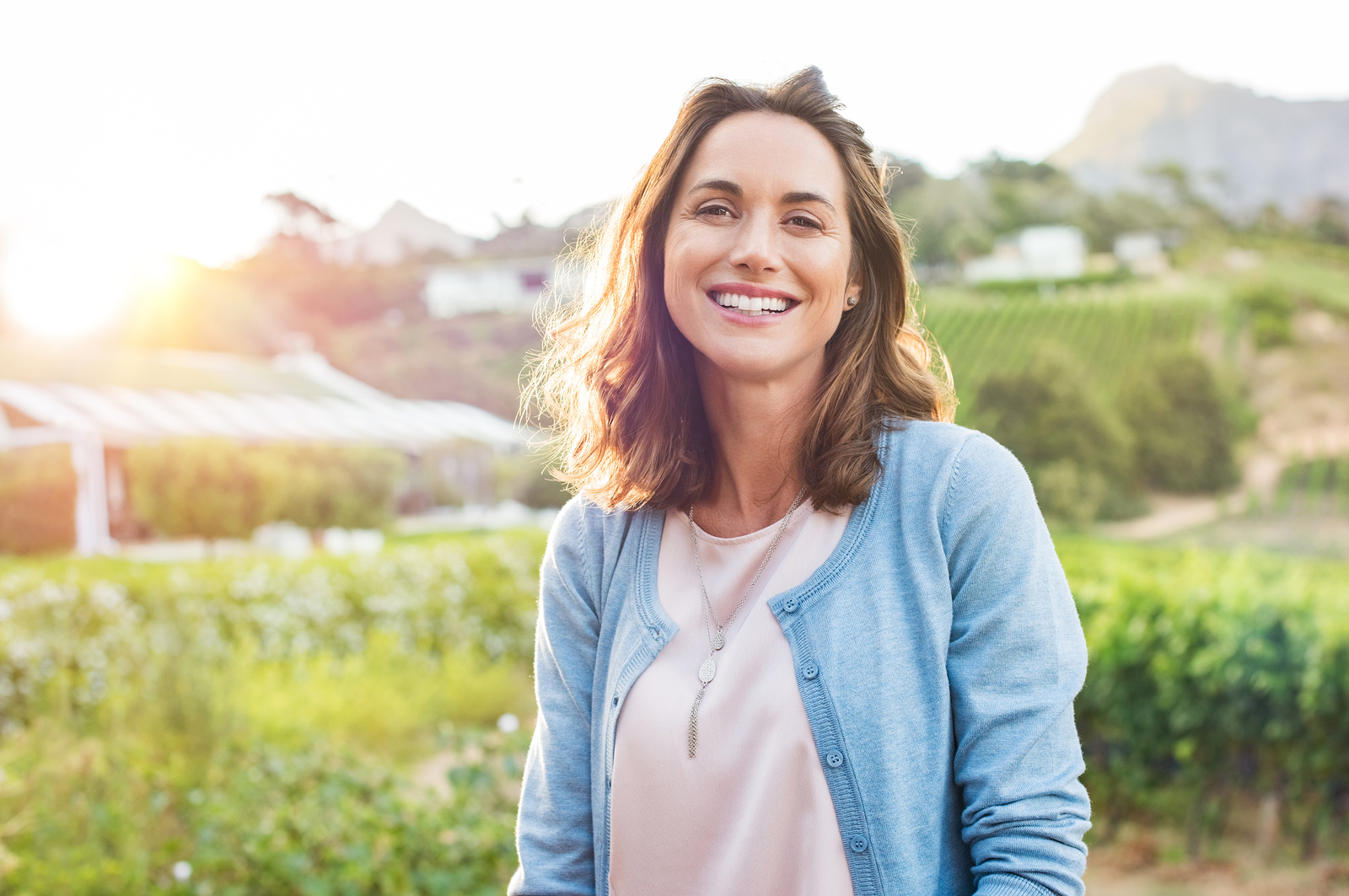 cheerful woman outdoors smiling after finding freedom for problematic drinking. Begin alcohol abuse treatment and therapy in Baltimore, MD 21210 at New Connections Counseling Center