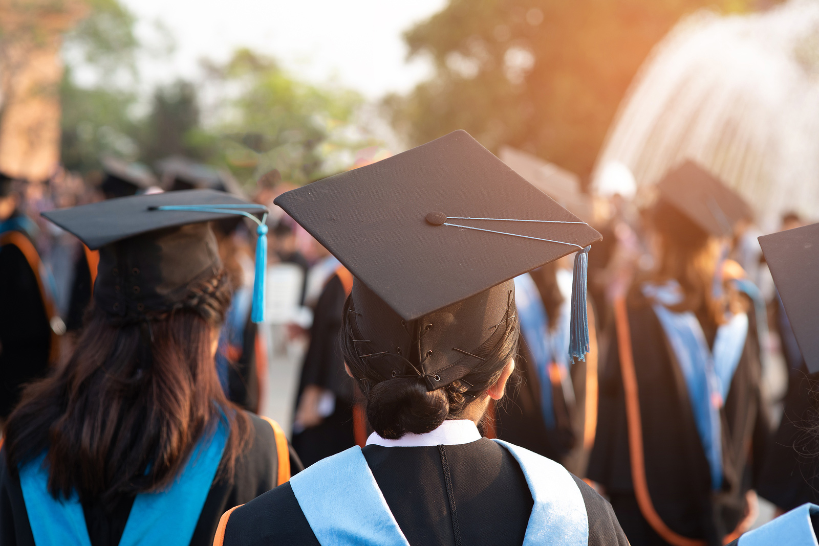 photo of the back of college graduates during graduation ceremony representing the life transition that graduation brings. Begin Counseling for life transitions in Baltimore, MD 21210 at the New Connections Counseling Center" width="300" height="200"