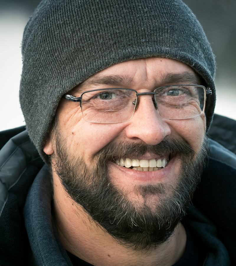 man in stocking cap and winter coat smiling at the camera representing the freedom you get from alcohol abuse treatment if you are an alcoholic or have problematic drinking. Get substance abuse treatment in Baltimore, MD 21210 at New Connections Counseling Center