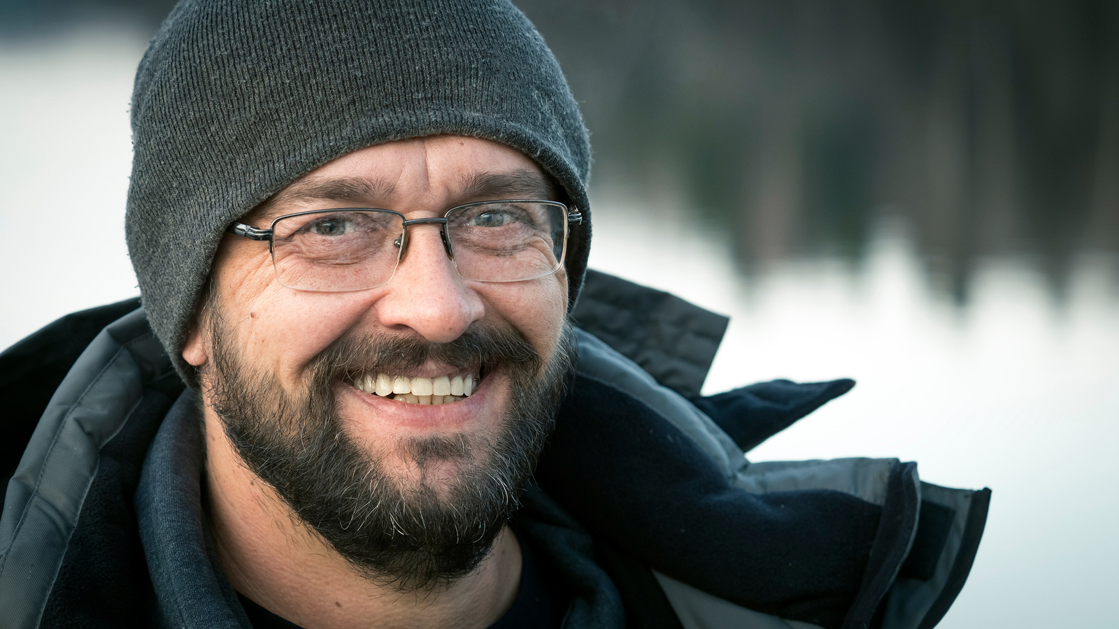 man in stocking cap and winter coat smiling at the camera representing the freedom you get from alcohol abuse treatment if you are an alcoholic or have problematic drinking. Get substance abuse treatment in Baltimore, MD 21210 at New Connections Counseling Center