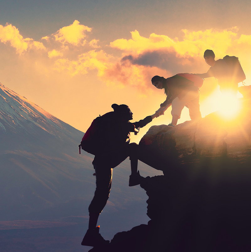 Image of three people hiking a mountain with a sunny and mountainous background. This image illustrates what trauma therapy and PTSD treatment in Baltimore, MD may be like. Processing trauma and PTSD is hard, but worth it. | 21210 | 21212