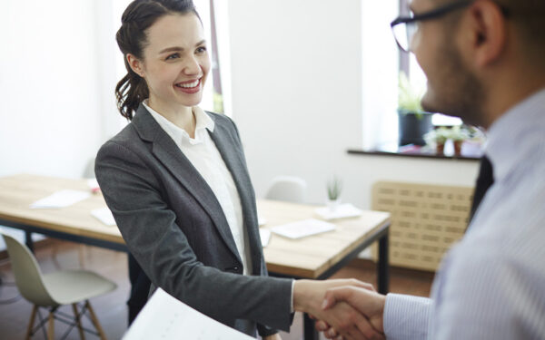 Businesswoman giving a handshake to her new employer. This represents how the excitement and anticipation of starting a new job can also trigger anxiety and depression.