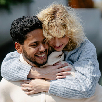 Photo of a couple holding each other in a loving moment. This represents how couples counseling in Baltimore can help you reconnect with your partner.