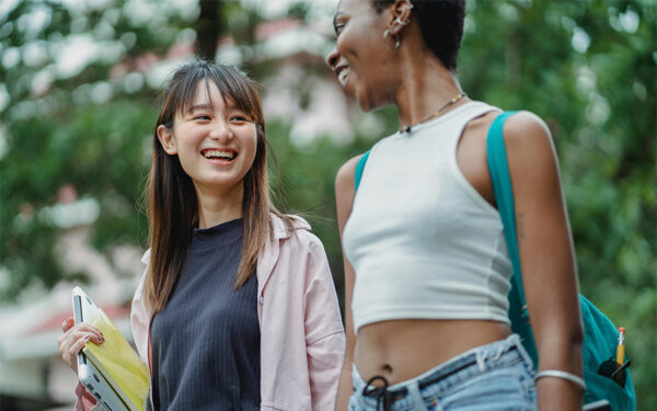 Two students leaving the campus for summer break. This represents how it's crucial for college students to follow mental health tips to take care of their well-being all year round.