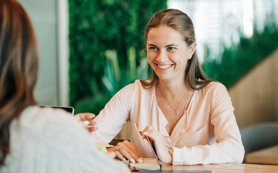 Young woman at a job interview looking happy and confident after our job hunting tips for young adults and seeking support in Baltimore, MD.