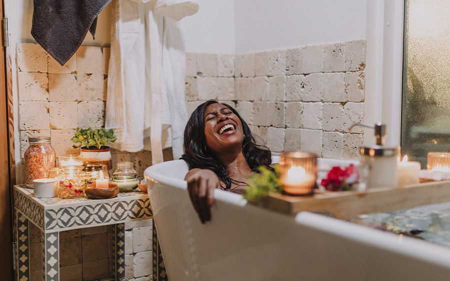 Woman relaxing in a bathtub, representing how you can spend Valentine's day alone and reclaim it for yourself.