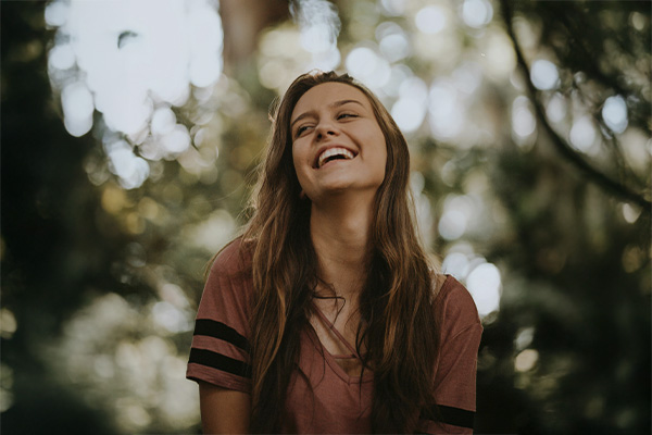 Woman looking happy and relaxed, represents how you can find an ADHD specialist to support your needs.