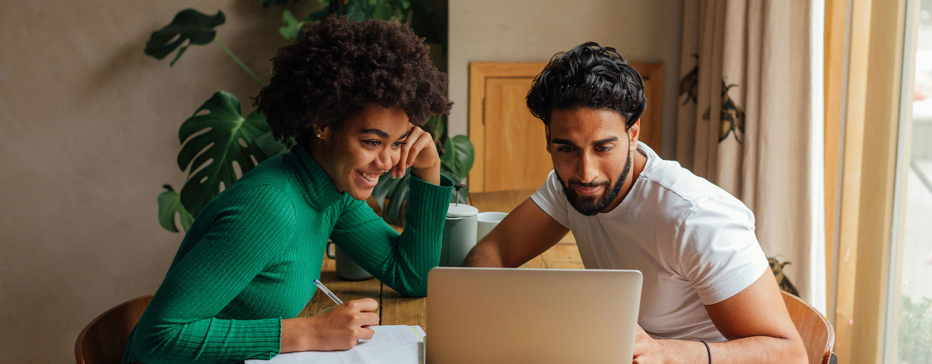 Woman and men working together on a laptop, represents how the support of an ADHD therapist in Baltimore can help you realize your potential. 