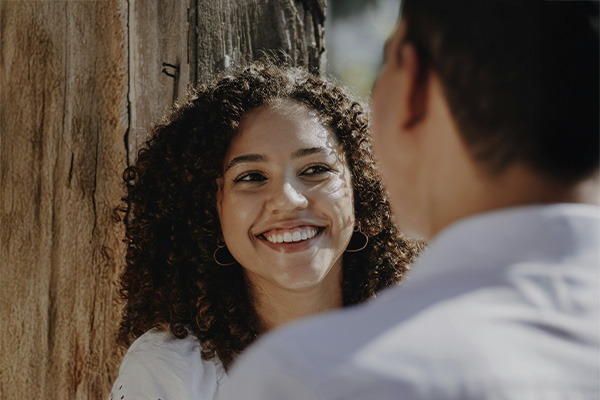 Woman smiling while looking to her parter, represents how working with a EMDR therapist in Baltimore can help you move forward and heal.